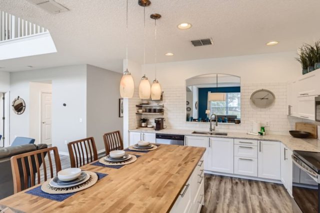 Heroes & Wizards Villa, Kitchen with stainless steel appliances and modern wood top island dining table