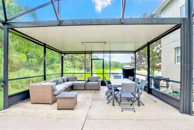 Pixel & Pixie Retreat, Outdoor lakeside patio with comfortable seating and dining table.