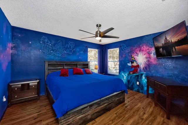 Wonderlands & Wizards Villa, The Fantasia Room with a King size bed and private bathroom, and large smart TV.