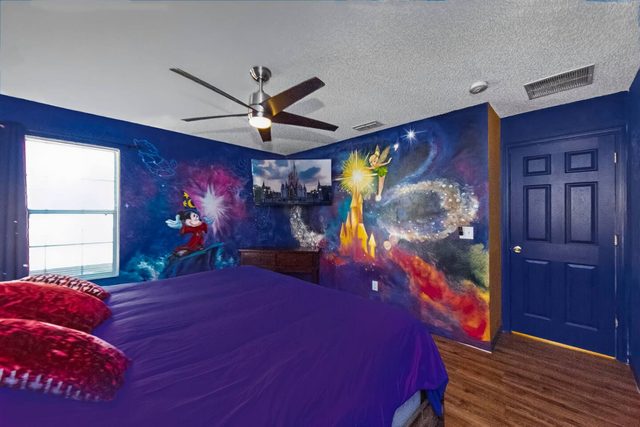 Wonderlands & Wizards Villa, The Fantasia Room with a King size bed and private bathroom, and large smart TV.