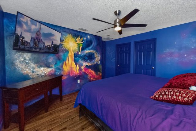Wonderlands & Wizards Villa, The Fantasia Room with a King size bed and private bathroom, and large smart TV.