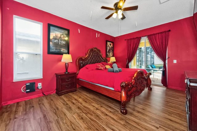 Wonderlands & Wizards Villa, The Gryffindor Room with a King size bed and private bathroom with separate tub and shower, and large smart TV.