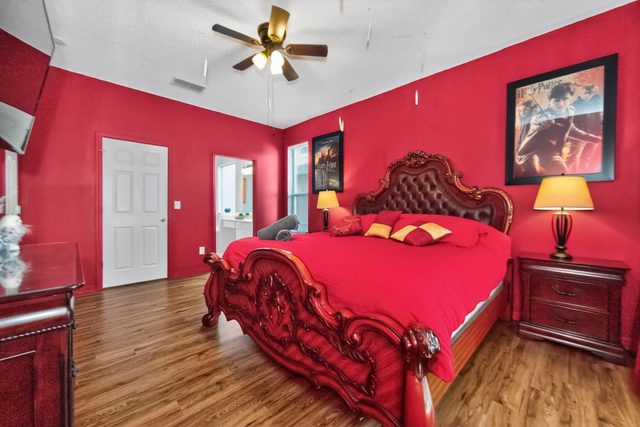 Wonderlands & Wizards Villa, The Gryffindor Room with a King size bed and private bathroom with separate tub and shower, and large smart TV.