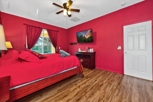 Wonderlands & Wizards Villa, The Gryffindor Room with a King size bed and private bathroom with separate tub and shower, and large smart TV.