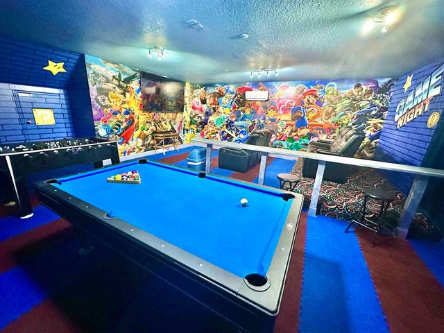 The Marvel Mansion, The Smash Brothers game room and theater! Featuring a pool table, foosball, large smart tv and movie theater reclining chairs!