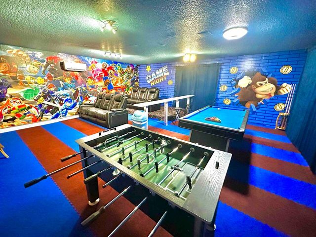 The Marvel Mansion, The Smash Brothers game room and theater! Featuring a pool table, foosball, large smart tv and movie theater reclining chairs!