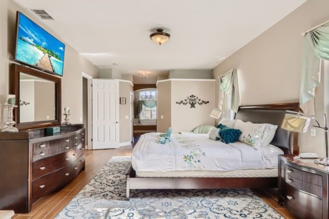 The Marvel Mansion, Master bedroom with king bed, work area, and ensuite private attached bathroom