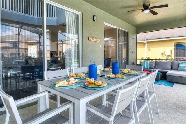 The Minion Mansion, Private pool with slide and covered lanai, lounge chairs, outdoor smart tv and outdoor dining with plenty of comfortable seating, and ping pong table.
